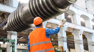 Man standing near gray metal equipment 2760243
