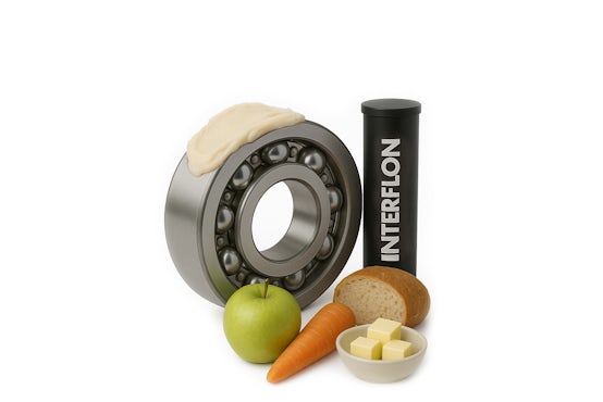 Rodamiento con grasa alimentaria, acompañado de manzana, zanahoria, pan, mantequilla y un cartucho de grasa alimentaria Interflon.